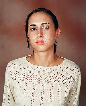 Portrait of a wild amp very attractive woman posing with semen on her face for an art project by artist Ashkan Sahihi